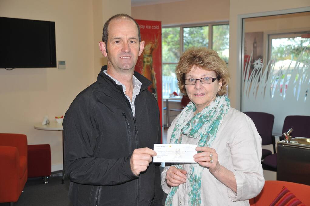 Grampians Wildflower Ride president Michael Kelly presents Alison Duxson from Grampians Community Health with a cheque for $1000. Pictures: BEN KIMBER.