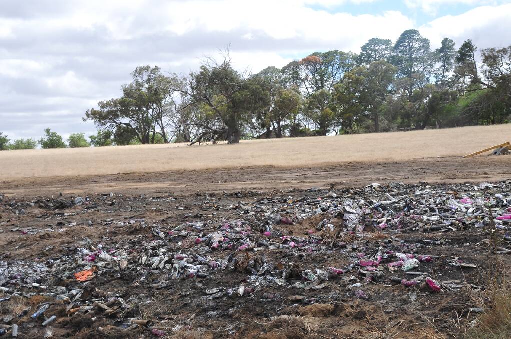 Aerosol cans still litter the scorched paddock beside the Western Highway.