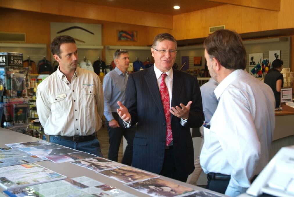 Premier Denis Napthine speaks with Ranger in Charge of the Grampians, David Roberts and Parks Victoria District Manager Graham Parkes about the damage the bushfires caused, during a visit to Halls Gap. Picture: BEN KIMBER.