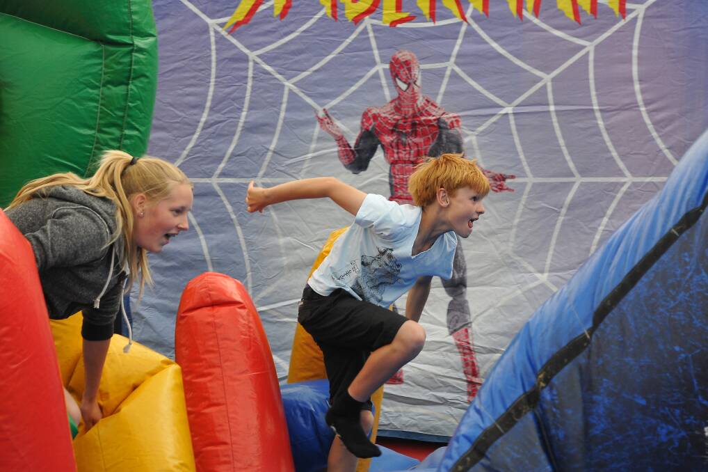 Youngsters Karissa and Lochie tackle the superhero jumping castle that was among the attractions at the first information session. Pictures: MARK McMILLAN.