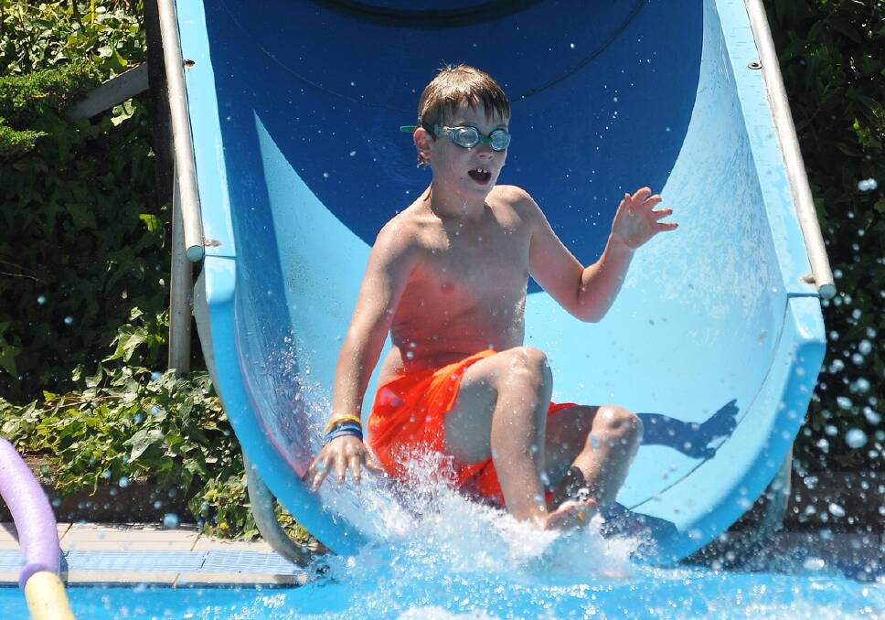 Kain Griffin hits the water after riding one of the water slides.