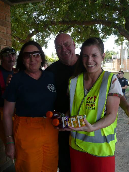 Cororooke Fire Brigade members Anne Llloyd and Adrian Richies receive some assistance from Rapid Relief Team volunteer Vivenne Henderson.