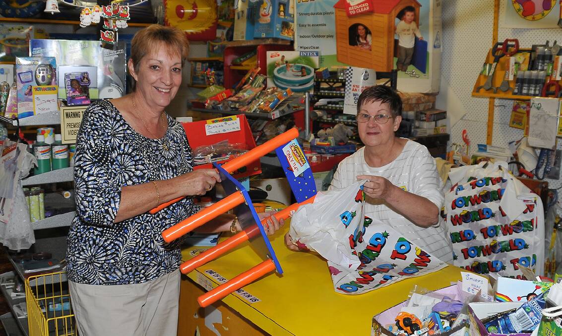 Janine Sibson makes a purchase on the last day of trade at Stawell Toyworld, assisted by store owner Kath Odd. Picture: MARK McMILLAN.