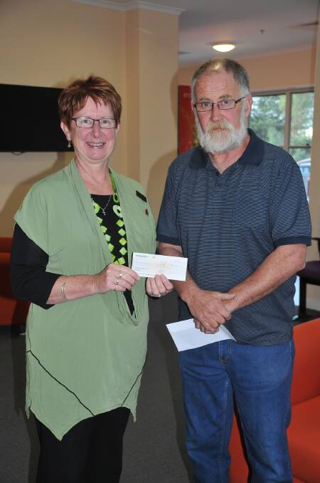 Skene Street School principal Robyn Anyon receives a $300 cheque from Grampians Wildflower Ride Secretary Gerard McAloon to go towards Chaplaincy in Stawell.