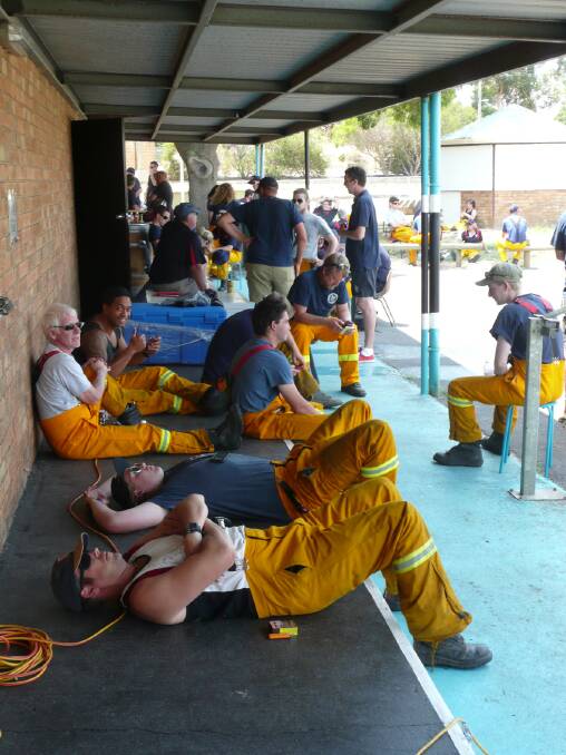 Weary firefighters take time to recover at a Rapid Relief Centre at North Park. Pictures: BEN KIMBER.