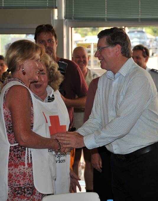 Victorian Premier Denis Napthine thanks Red Cross volunteers Annette Monaghan and Geraldine Monaghan for their efforts.