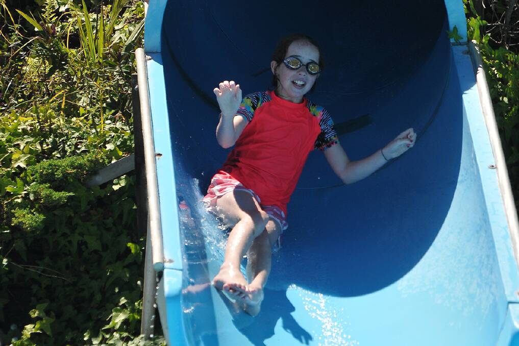 Claire Burmester emerges from the biggest water slide at the Outdoor Pool. 