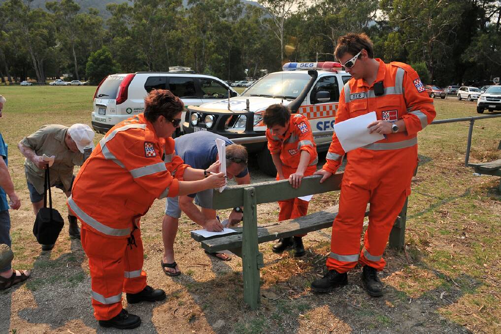 State Emergency Service volunteers take the details of people choosing to stay and defend or evacuate. Pics: Ben Kimber