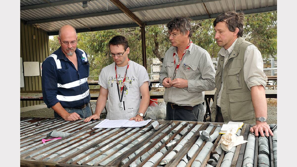 Wesley Edgar, Anthony Schofield, David Huston and Eugeniy Bastrakov look over core samples collected by Navarre Minerals.