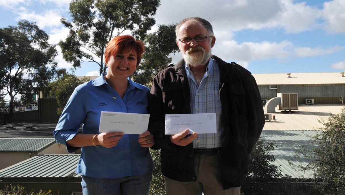 Kelly Cosson with a grant for Interchurch Netball and Gerard McAloon with a grant for the Grampians Wildflower Ride.