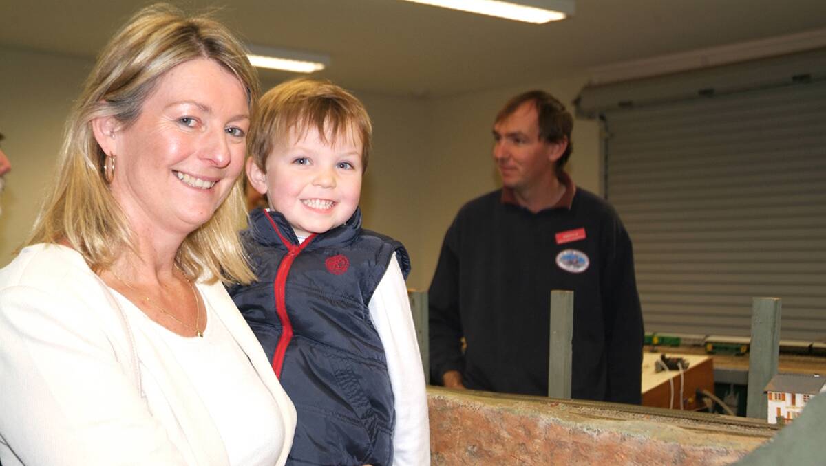 Cr Karen Hyslop shows her son Blake the model railroad display at the Powerhouse, with Grampians Model Railroaders member Andrew Cray in the background. 