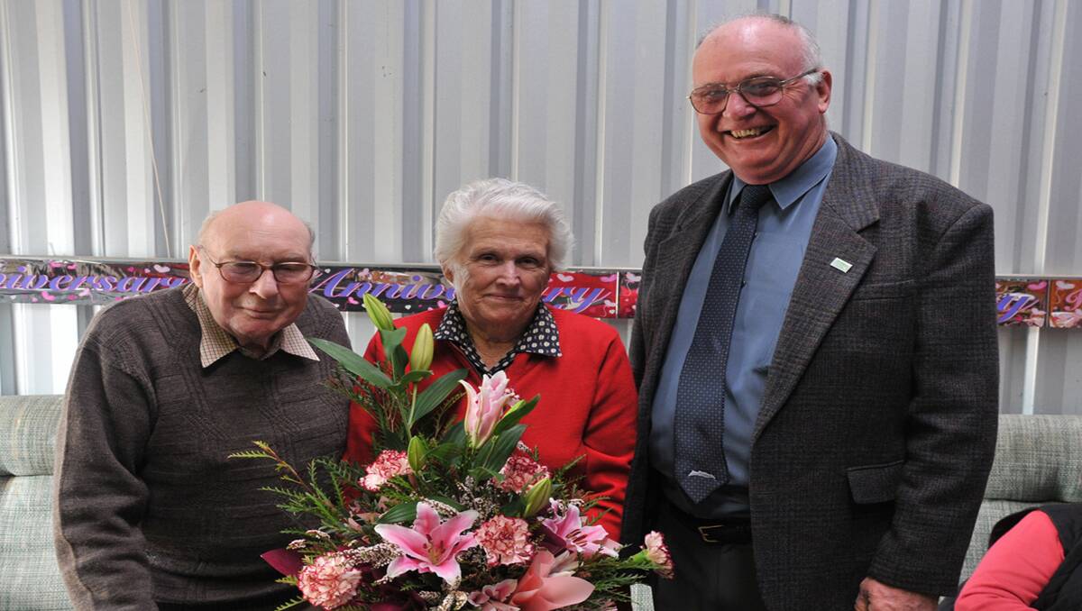 Errol and Dot Gready receive flowers from Northern Grampians Shire Councillor, Wayne Rice, for their diamond wedding anniversary. Picture: MARK McMILLAN