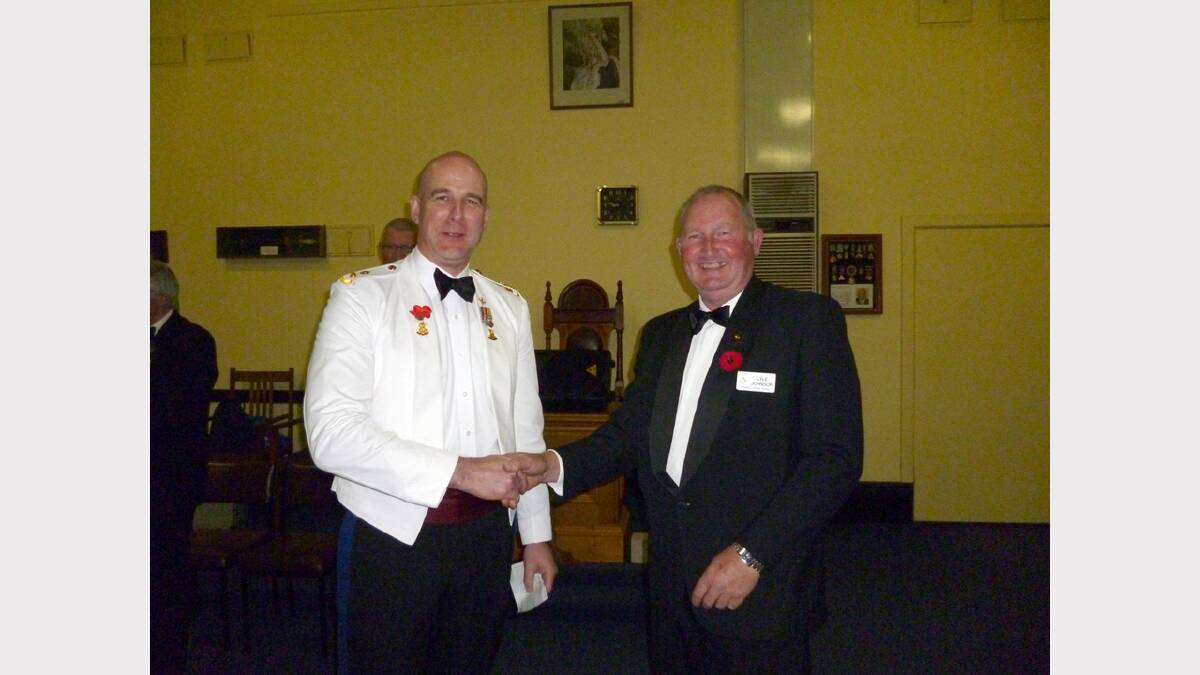 Worshipful Master Lyle Johnson presents a cheque to Stawell Secondary College principal Colin Axup following the Unknown Soldier ceremony.