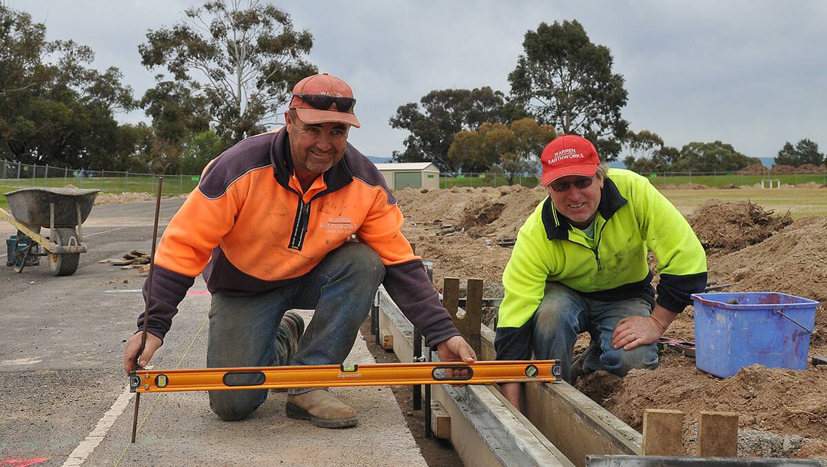 Dale Burke and Dean Cameron from Warren Earthworks, work on new curb and channelling at North Park. Picture: KERRI KINGSTON 
