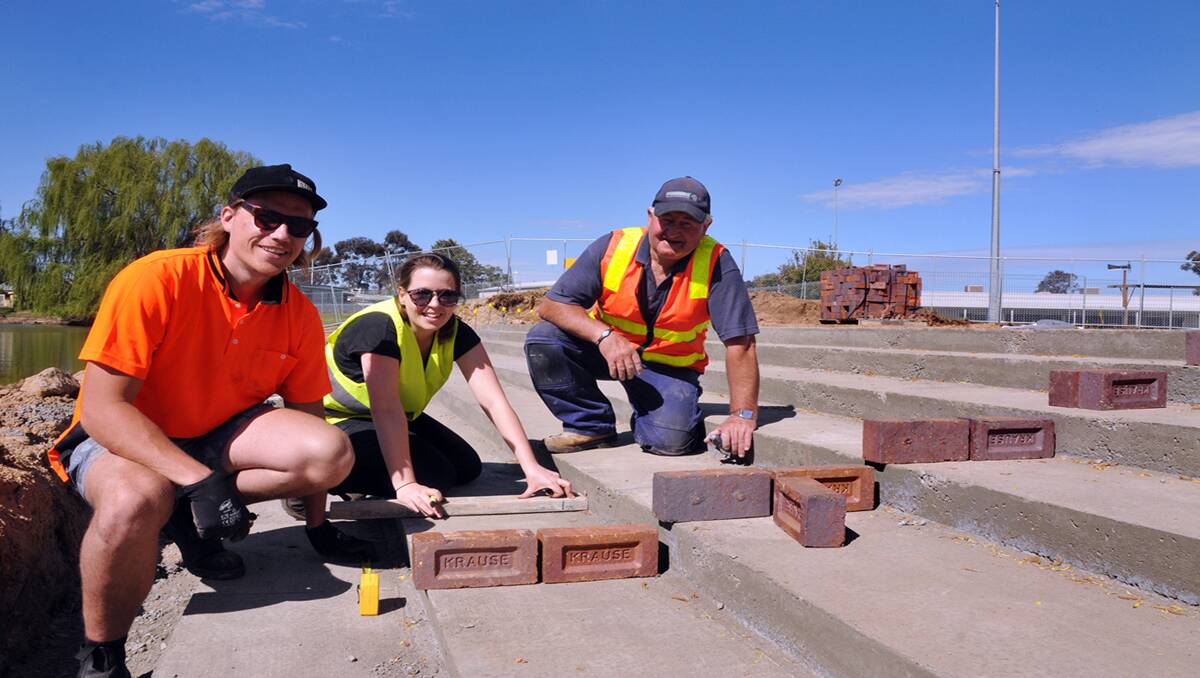 Working out laying the bricks at the Cato Lake project from Stawell, bricklayer Des Pickford (right) were university students Dan McKenna and Cathryn Walter. Picture: KERRI KINGSTON