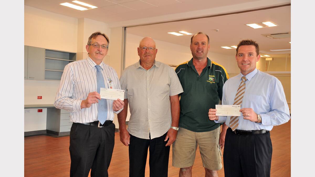 East Grampians Health Services Clinical Director Peter Armstrong (left) and Stawell Regional Health chief executive officer Rohan Fitzgerald (right) receive cheques from A Day on the Hill organisers Joe Peacock and Andrew Murphy.