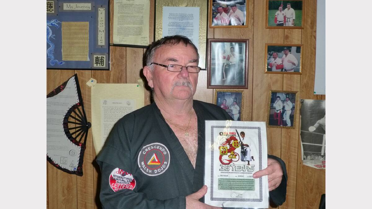Percy Walsh with his 35 year award.