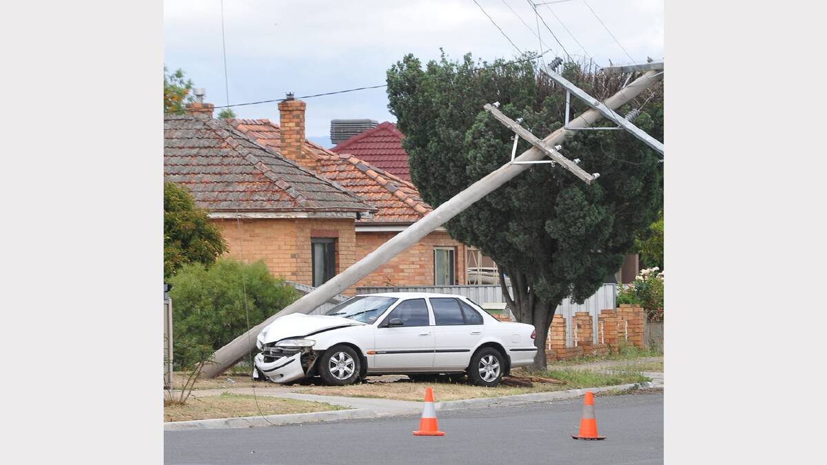 The powerpole rests on top of the vehicle following the crash in Dawson Street.