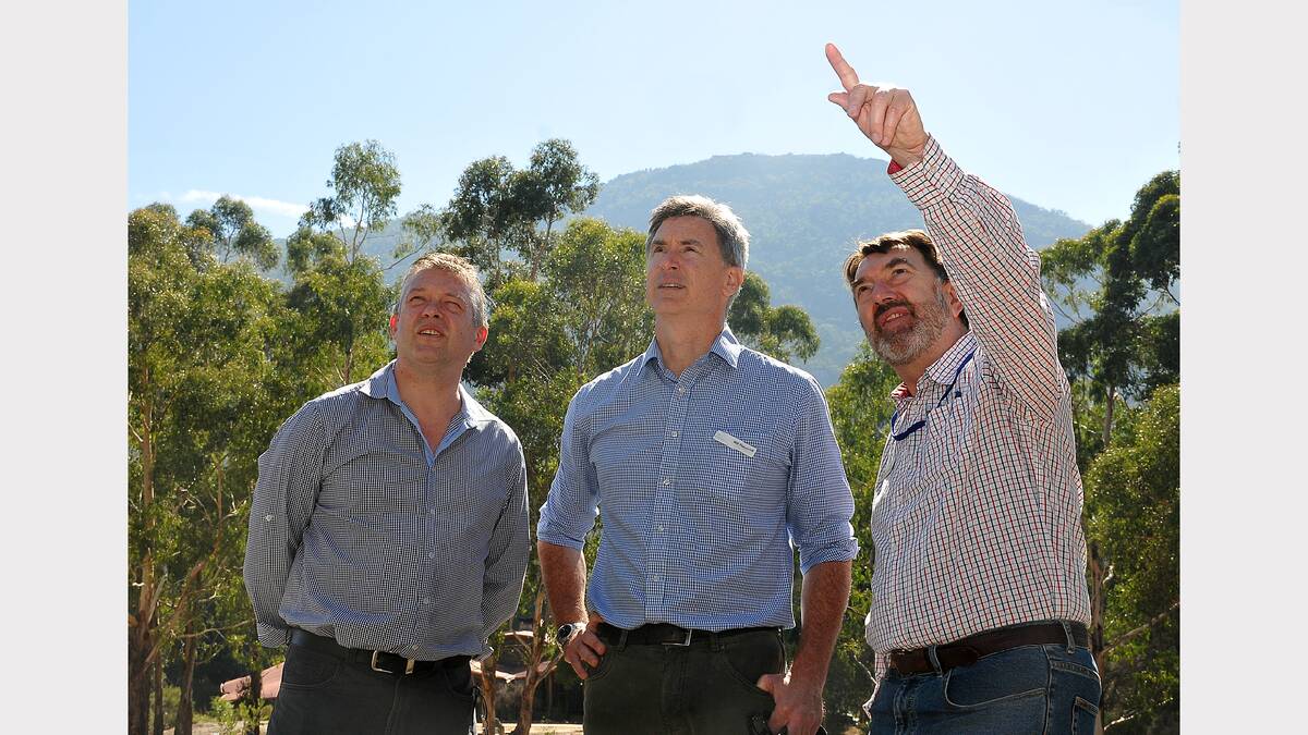 Ryan Smith, Will Flamsteed and Graham Parkes look out over a burnt area of the Grampians National Park as they discuss what is required to ensure recovery efforts continue for communities.
