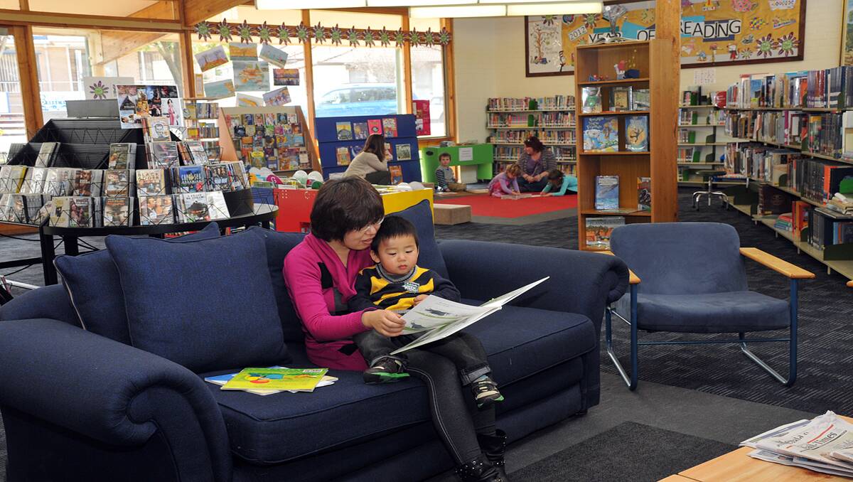 Dora He is pictured reading to her son Jason in the revamped Stawell Library. The library has taken on a whole new look with renovations carried out over a five day period. Picture: KERRI KINGSTON