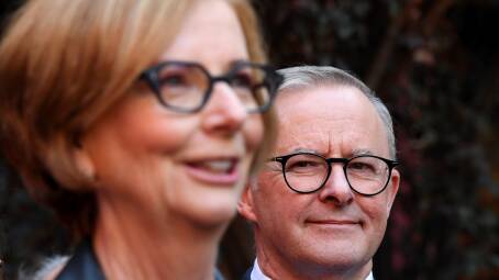 Australian Opposition Leader Anthony Albanese listens to former Australian prime minister Julia Gillard speak to the media during a press conference in Adelaide on Friday. Picture: AAP