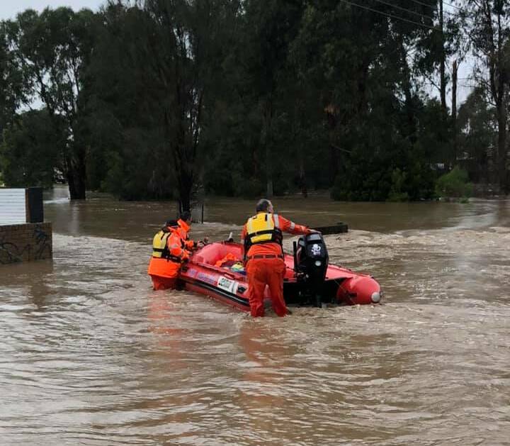 FLOODWATER: The boat crew navigating its way through the flooded streets of Traralgon. Picture: CONTRIBUTED