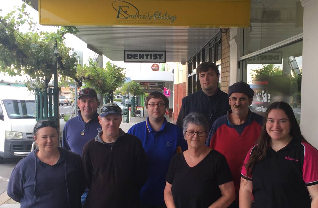 SAYING GOODBYE: EmbroidAbility staff members Jodie Harvey, Tim Miller, John Syrad (instructor), Hamish Hartwich, Sue Prior (business manager), Josh Moorfoot, Kim Griffiths, and Rachael Lewis. Absent: Jasmine Walker, Ashlee Milne, and Josh Perry. Picture: KLAUS NANNESTAD