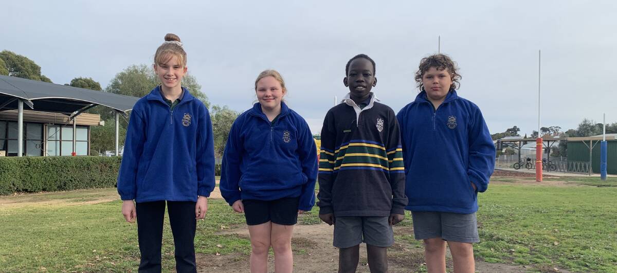 NEW: Grace, Marli, Angok and Jack are excited to see new turf laid down on their school oval. Picture: TALLIS MILES