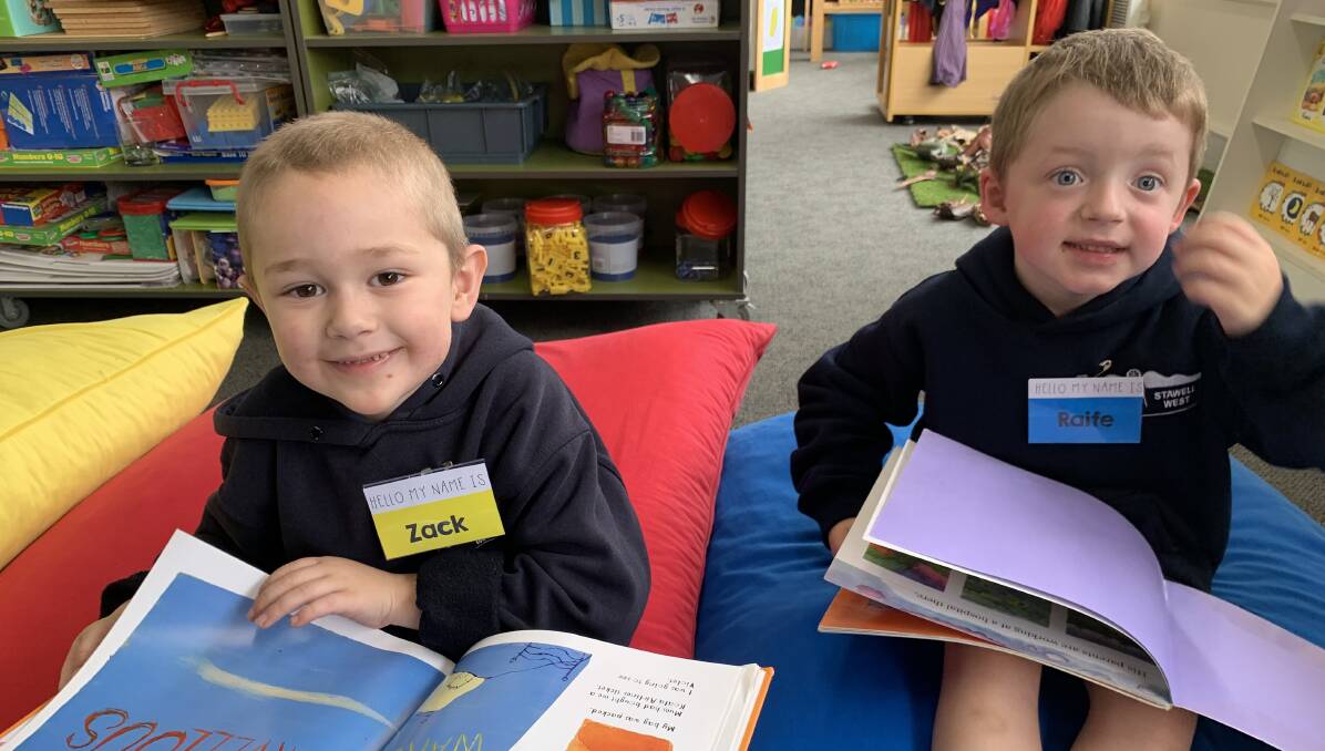 LEARNING: Some of Stawell West Primary School's new pupils Zack, 5 (left) and Raife, 5, did some reading on their first day. Picture: TALLIS MILES