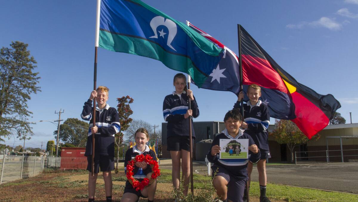 PRIDE: School leaders Max, Romy, Meika, Blake and William with the flags at the Galipoli Tree. Picture: PETER PICKERING