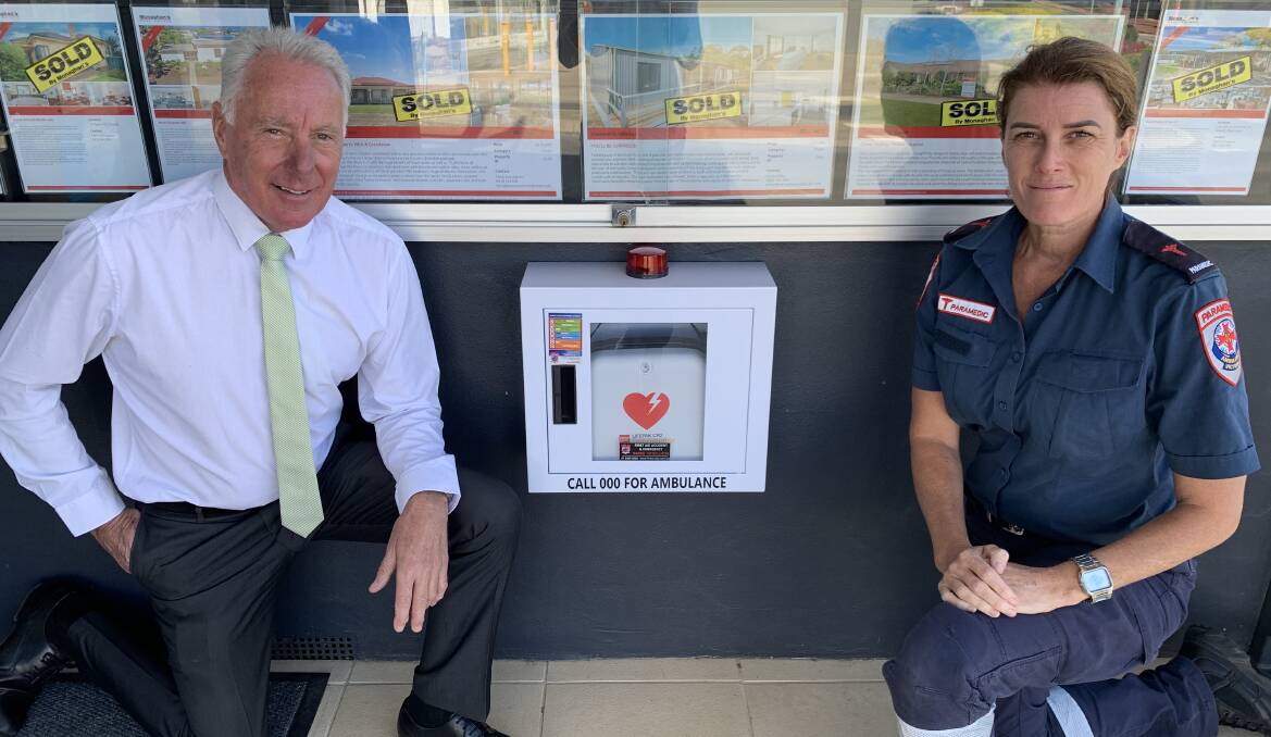 LIFE-SAVING: Terry Monaghan (left) and Kim Hayes with the new AED at the front of Monaghan's Real Estate. Picture: TALLIS MILES