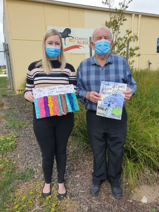 COMMUNITY: Stawell Agricultural Society secretary Sarah Baker and president Don Brown with some of the primary school student entries for the 2022 Stawell Show schedule booklet. Picture: CONTRIBUTED