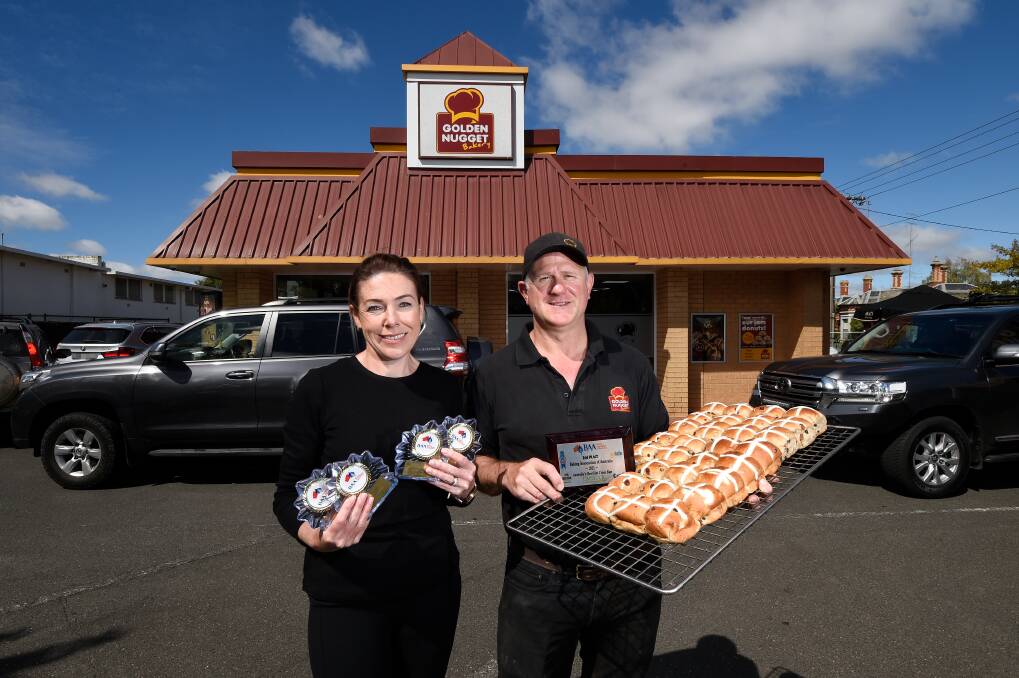 Golden Nugget Bakery owners Alicia and Wal Matthews with their award-winning hot cross buns. Photo: Adam Trafford