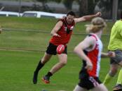 THUD: A Warrior thumps the ball downfield against the Horsham Saints. Picture: STEPHEN WALKER