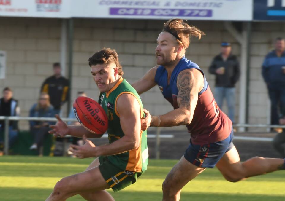 EVASION: Dimboola's Thomas Cree tries to sidestep a determined Deek Roberts at City Oval on Saturday afternoon. Picture: ALEX BLAIN