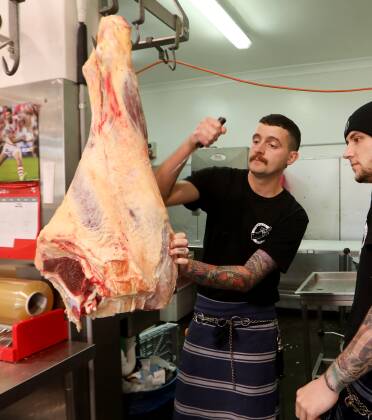 Owner of Cleaver & Co Quality Meats Wollongong Lachy Kerr, left, with apprentice butcher Joshua Borg. Picture by Sylvia Liber