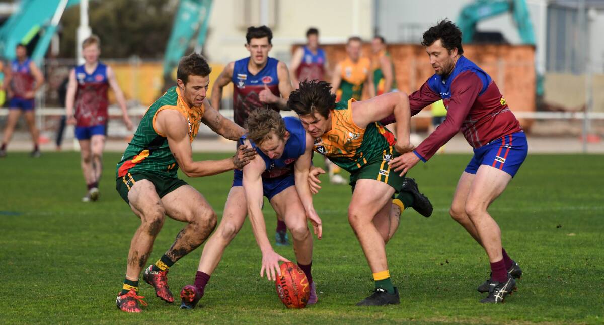 Ben Miller, Harrison Combe, Sam Godden and Allistair McKinnon fight for a loose ball in the round 12 WFNL match at Horsham City Oval. Picture by Lucas Holmes