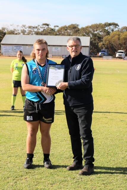 Southern Mallee footballer Jamie Eckermann receives his Blue Ribbon Foundation Spirit of Football award from Rainbow police officer Leading Senior Constable Tony Clark. Picture supplied