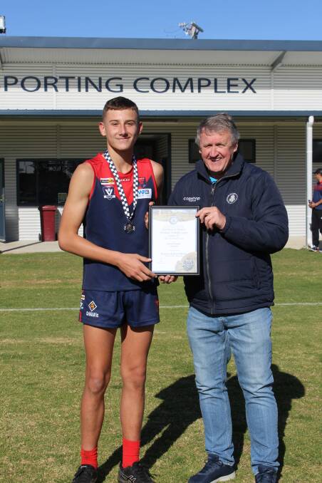 Laharum's Chase Whelan receives his Blue Ribbon Foundation Spirit of Football award from foundation member Les Power. Picture supplied