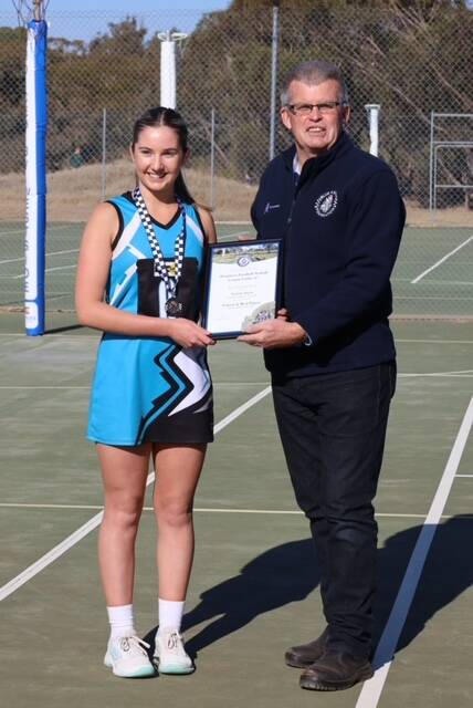 Southern Mallee's Nekeisha Bastin receives her Blue Ribbon Foundation Spirit of Netball award from Rainbow police officer leading senior Constable Tony Clark. Picture supplied 