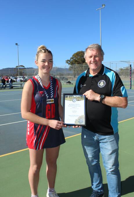 Tarah Bond receives her Blue Ribbon Foundation Spirit of Netball award from foundation member Les Power. Picture supplied