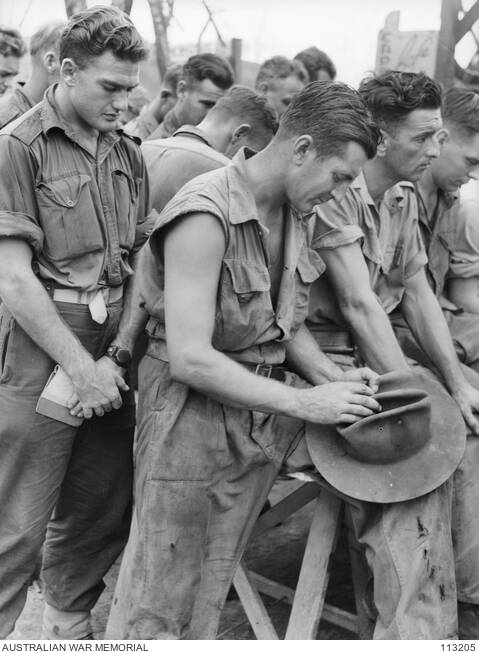 A TIME TO REFLECT: Members of the 7th Division and Ran Commandos at prayer during the thanksgiving service held in the Salvation Army hut in Balikpapan, Borneo on Victory in the Pacific Day on August 15, 1945. Photo: Australian War Memorial