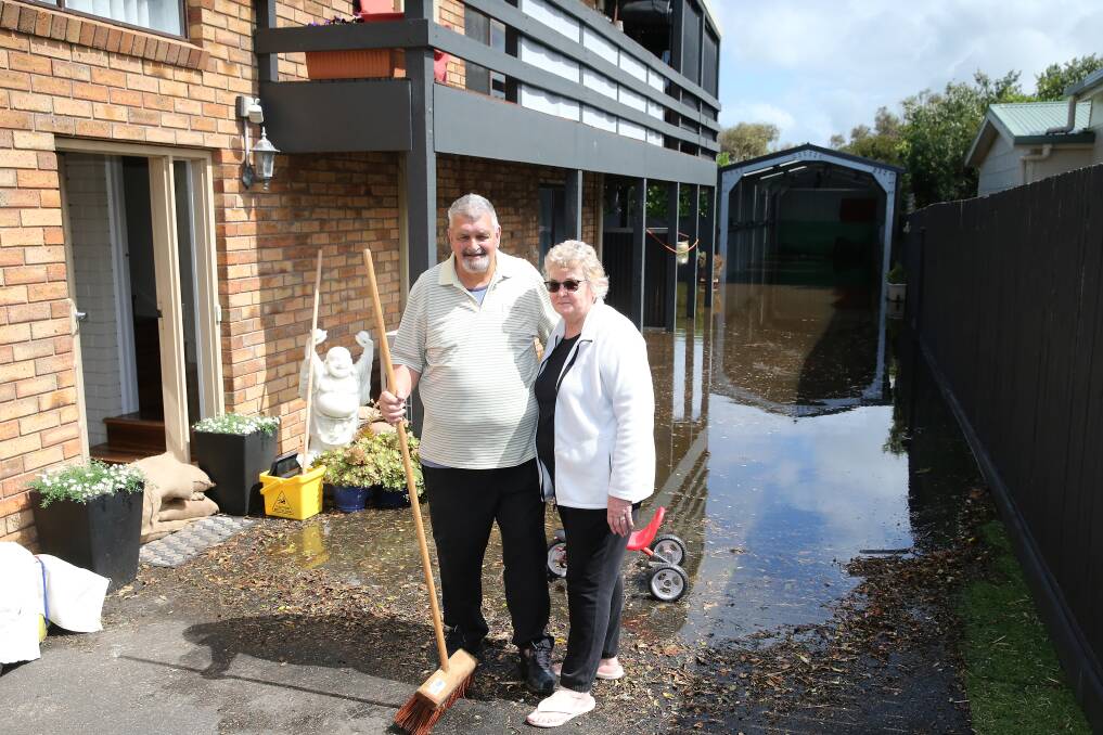MOPPING UP: Pam and Trevor Hockley after flood waters seeped into their Port Fairy Griffiths Street house. Picture: Mark Witte