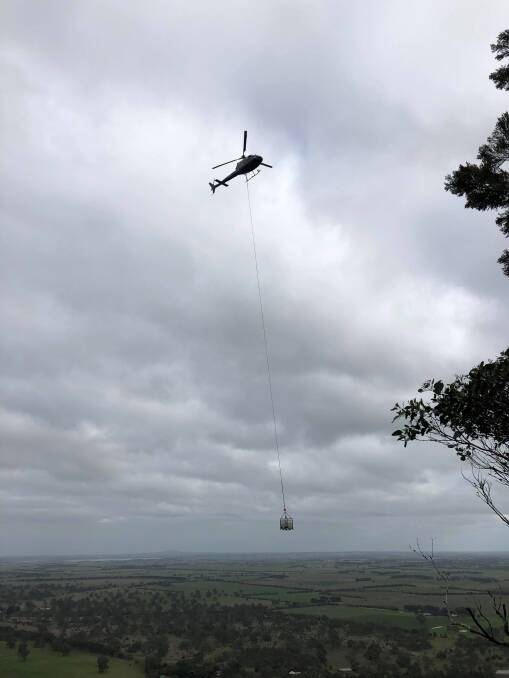 A helicopter drops building materials to inaccessible parts of the Grampians Peaks Trail. Picture: Ryan Tracey 