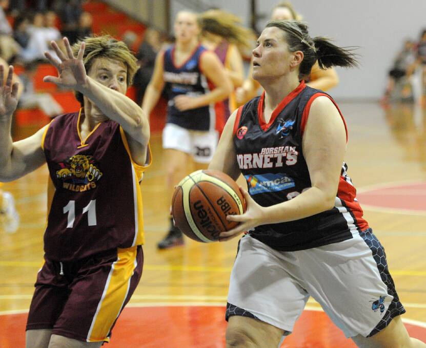 Jodie Hendy defends Caitlyn Story as she makes her way to the basket in Horsham's big win over Stawell.