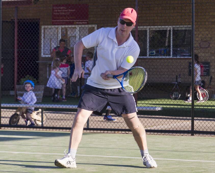Approaching: Phil Hutton played a low drop shot as he made his way to the net during Stawell's Friday night tennis competition. Pictures: Peter Pickering.