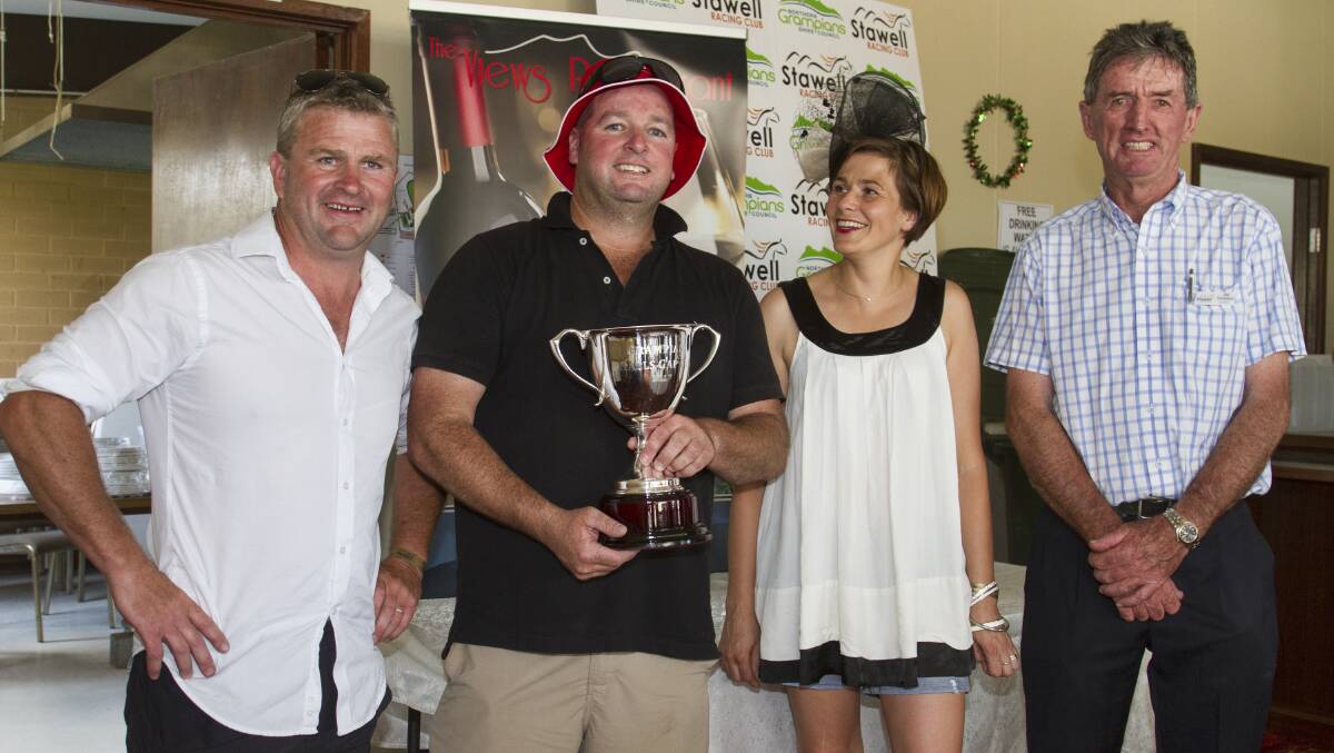 Rowan and Josephina McDonald present Sovereign Duke trainer Nathan Hobson with the 2017 Cup along with Stawell Race Club president Ian Nicholson. Picture: Peter Pickering
