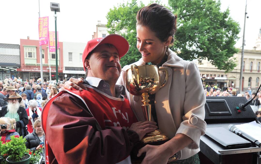 SPECIAL MOMENT: Michelle Payne and brother Stevie, the Melbourne Cup-winning strapper, celebrate their victory at Ballarat Town Hall. Picture Lachlan Bence.