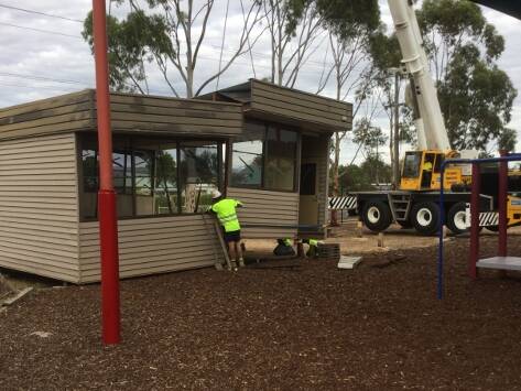 Going, going, gone: Machinery is brought in as the old portables are prepared for removal from the grounds of St Pats, to make way for new portables.