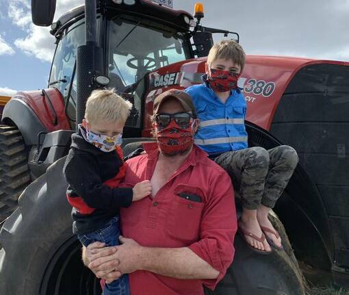 Minyip farmer Ryan Milgate, centre, took this photo to put towards the #masksonfarm campaign. Picture: Supplied